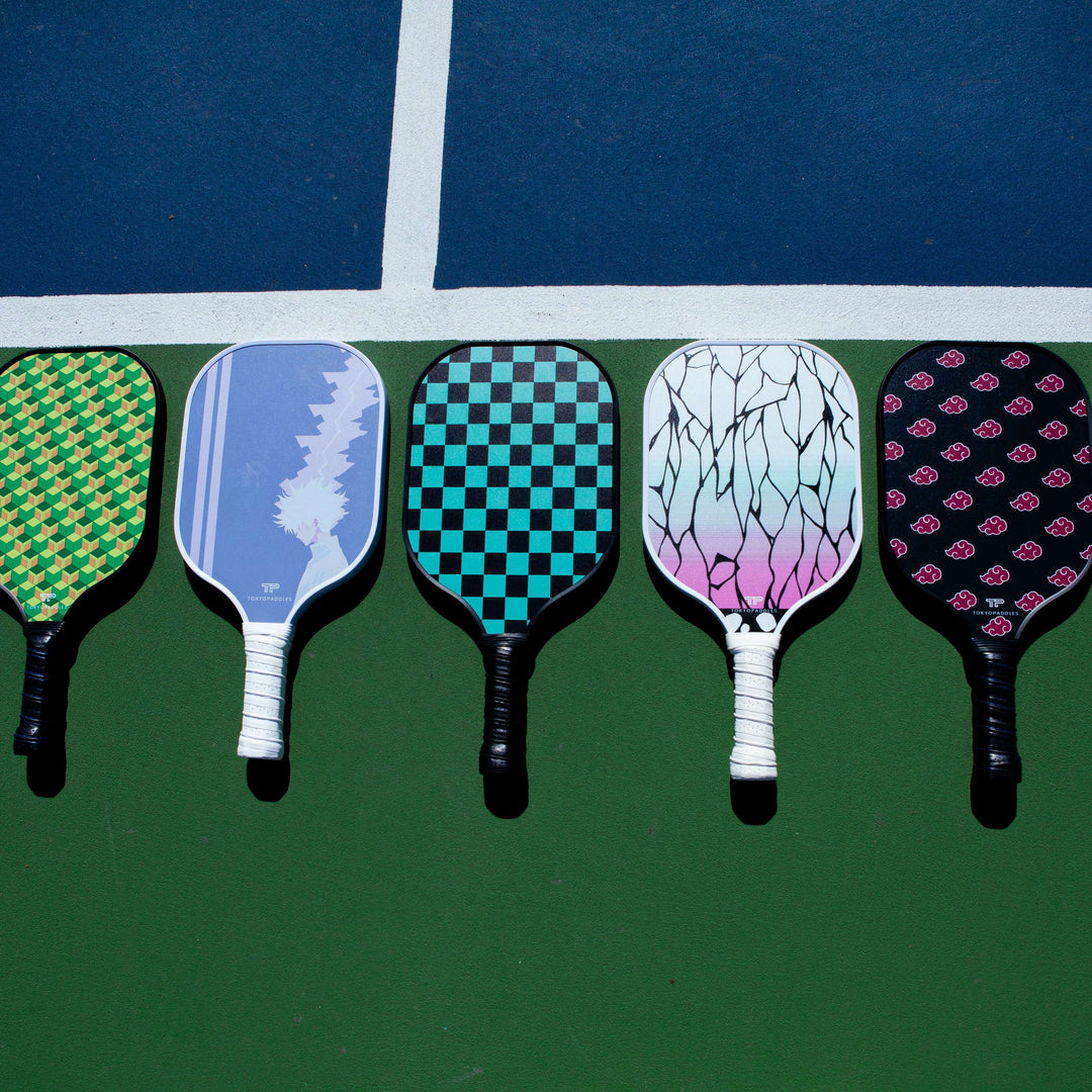 An informative illustration on the cost of pickleball paddles. The image shows a variety of pickleball paddles with varying designs and materials, with price tags accompanying each. The background com