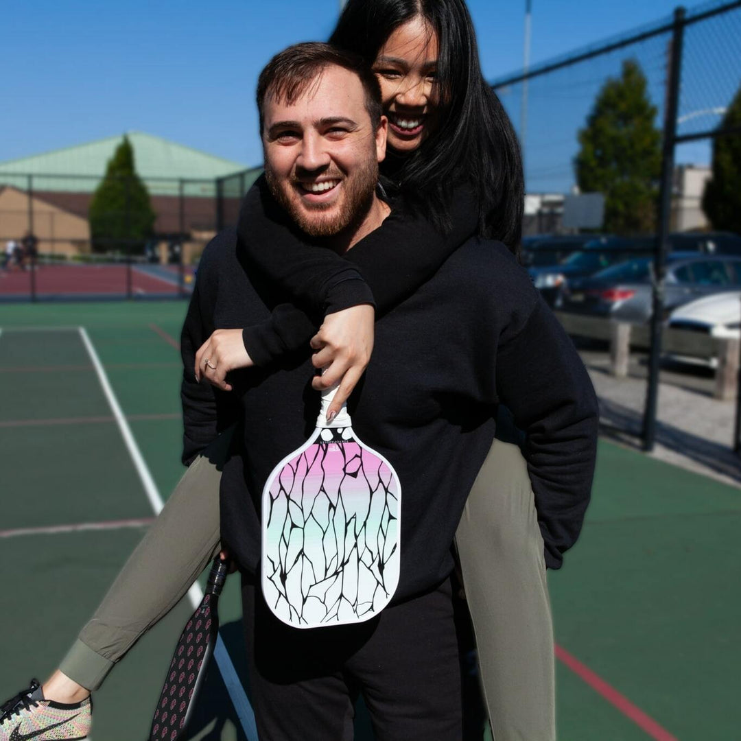 Create an illustrative guide book cover depicting about 'Power Play: A Guide to Heavyweight Pickleball Paddles'. The cover should feature a boldly powerful pickleball paddle at the foreground, emphasi