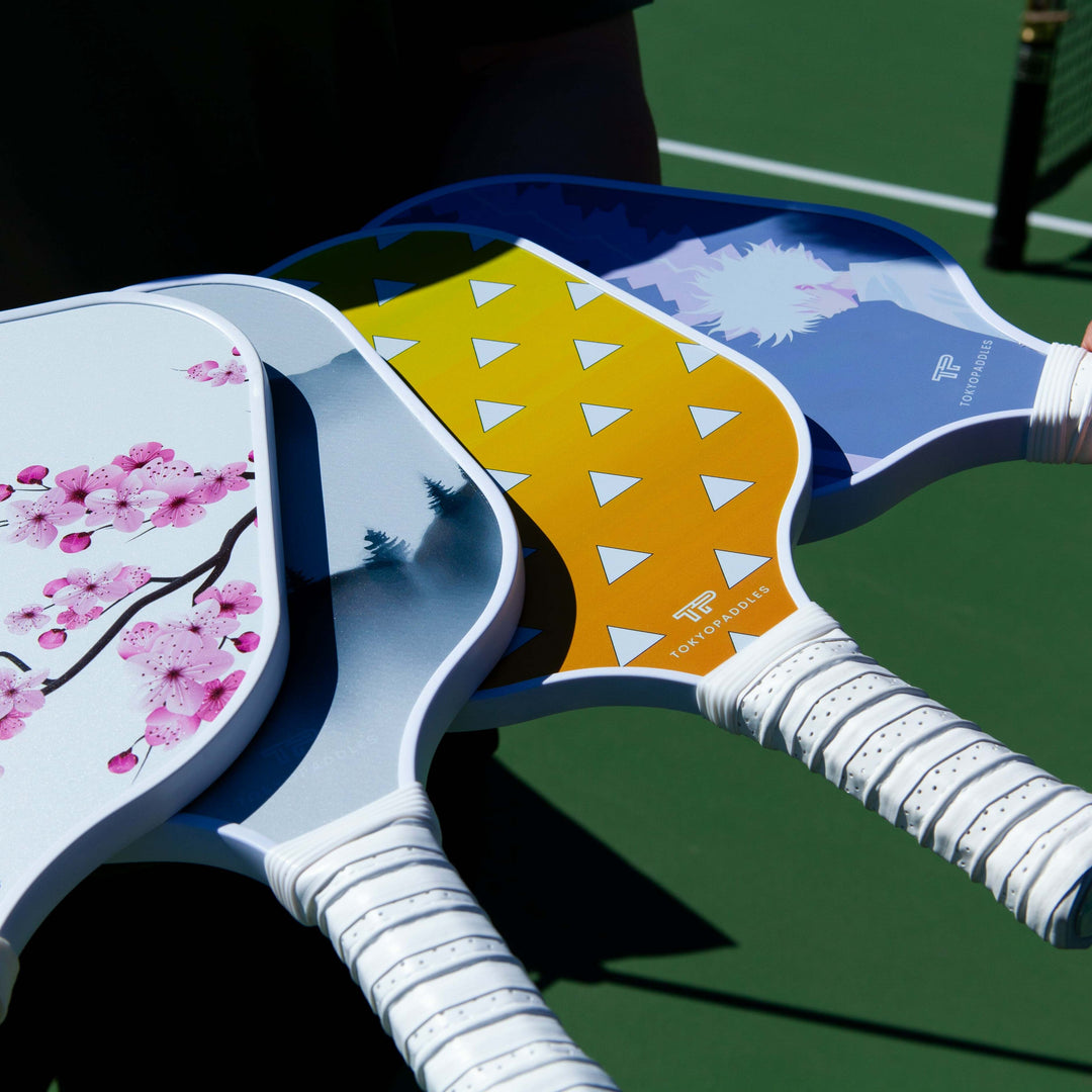 A selection of top-rated pickleball paddles specifically designed for intermediate level female players. Each paddle has a comfortable, ergonomic grip for easy handling and expert control. The paddles